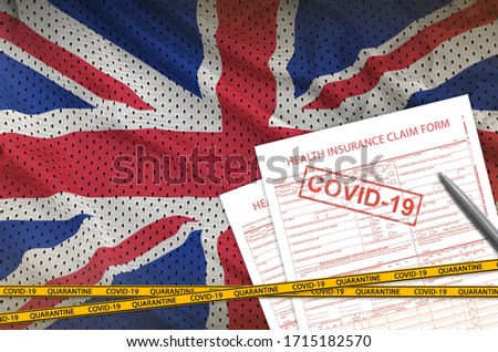 Great britain flag and Health insurance claim form with covid-19 stamp. Coronavirus or 2019-nCov virus concept