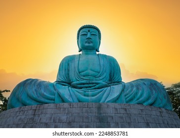 Great Buddha or Kamakura Daibutsu statue at sunset time.  Famous big Buddha statue inside Wat Phra That Doi Phra Chan temple. Lampang Province, Thailand. - Powered by Shutterstock