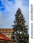 The Great Christmas tree in Place Kleber, Strasbourg, France, the capital of Christmas, with a historic half-timbered house in the background