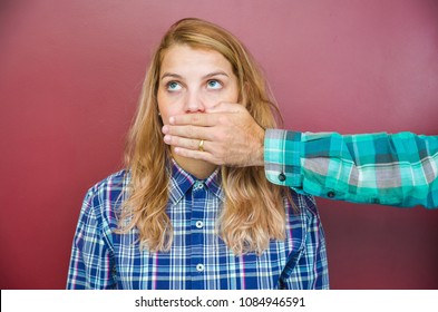 Great concept of male censorship, woman with mouth covered by man's hand. - Powered by Shutterstock