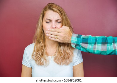 Great concept of male censorship, woman with mouth covered by man's hand. - Powered by Shutterstock