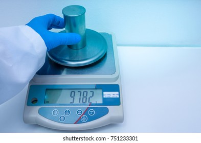 Great concept of research and development, hand measuring the density of a liquid with the pycnometer.