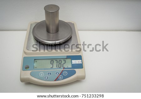 Great concept of research and development, hand measuring the density of a liquid with the pycnometer.