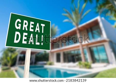A Great deal sign with bold letters in front of a luxury house. Real estate concept selling a mansion with discounted prices.