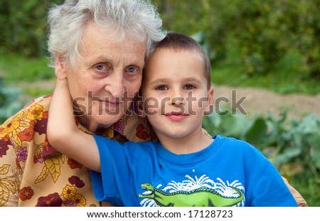 Similar – Grandma cuddles up with her grandson