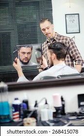 Great Job Done. Young Handsome Bearded Man Looking Precisely At His Mirror Reflection And Evaluates Barber Job Done