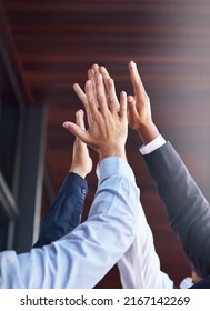 Great Job Team. Cropped Shot Of A Group Of Unidentifiable Businesspeople High Fiving In The Office.