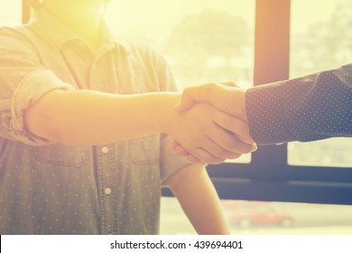 Great job,Sealing a deal,Successful business,Handshake,Businessman join together,Good agreement.two business people shaking hands standing at the working place,selective focus,Vintage tone,copy space

