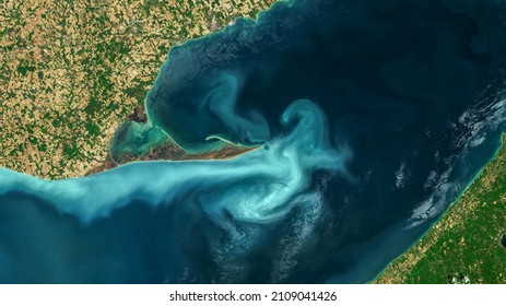 The Great Lakes, Aerial turquoise ocean photo from clear sky, top view of sea texture background, 16:9 ratio wallpaper, blooms of phytoplankton in Great Lakes. Elements of this image furnished by NASA - Shutterstock ID 2109041426