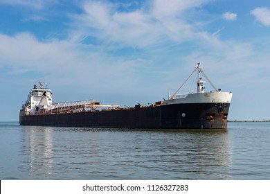 A Great Lakes bulk carrier ship headed for the Cuyahoga River in Cleveland, Ohio from Lake Erie.  The ship is laden with iron ore destined for a steel mill located upriver.