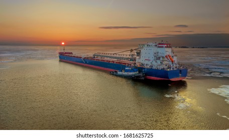 Great Lakes Ship In The Icy Waters At Sunset