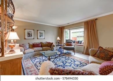 Great Living Room Interior Boasts Vintage Wet Bar With Wrought Iron Shelves, Comfortable Upholstery Furniture Atop Colorful Rug And Cozy Window Seat Topped With Pillows. Northwest, USA