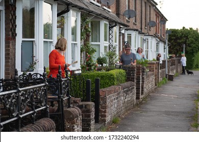 Great Missenden, Bucks/UK: May 7 2020: People Stand Outside A Row Of Cottages Clapping And Cheering For The NHS And Care Workers During The COVID19 Pandemic. All Women, Houses Look Identical.