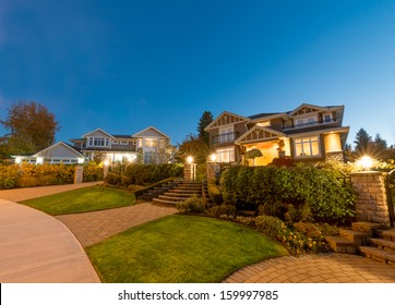 Great neighborhood. Luxury houses with nicely  paved doorway at dusk, night time in suburbs of Vancouver, Canada.