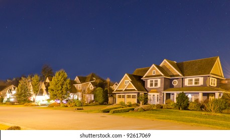 Great Neighborhood At The Night Time. The Suburb Houses At Sunrise-sunset Night Time.