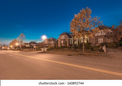 Great Neighborhood. A Row Of The Luxury Houses At The Empty Street At Dusk, Night Time In Suburbs Of Vancouver, Canada.