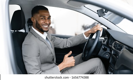 Great Offer. Businessman Buying Car Gesturing Thumbs Up Sitting In Driver's Seat Testing Auto In Dealership Showroom. Panorama, Selective Focus - Shutterstock ID 1656774388