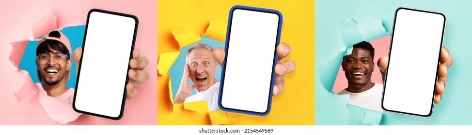 Great Offer. Three Excited Young Diverse Men Holding 3 Big Cell Phones With White Blank Screen In Hand, Showing Close Up To Camera Through Torn Paper Hole. Gadgets With Empty Free Copy Space, Banner