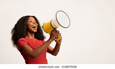 Great Promo. Excited Black Lady Using Megaphone For Making Announcement, Cheerful African American Woman Holding Loudspeaker, Sharing News While Standing On White Background, Panorama, Copy space