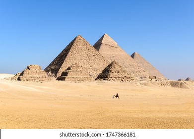 The Great Pyramid Complex Of Giza With Camel Caravan Walking Through In Front Of The Egyptian Pyramids- Giza- Cairo -Egypt