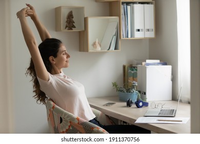 With Great Relish. Serene Female Student Relaxing After Long Time Of Distant Learning By Laptop At Home Office. Happy Young Woman Satisfied With Finishing Work On Pc Stretch Muscles Lean Back On Chair