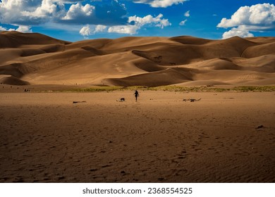 The Great Sand Dunes NP in Colorado is a hidden gem with vast dunes against a beautiful sky. It offers a surreal experience for hikers and sandboarders. It's a must-visit for nature lovers. - Powered by Shutterstock