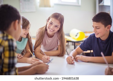 Great School Work.  Teenagers Students Sitting In The Classroom And Talking. 