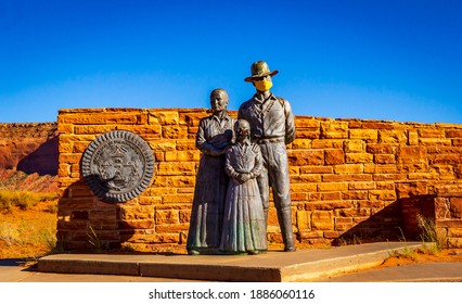 Great Seal of the Navajo Nation and Bronze Navajo Family Statue (with face mask) at the entrance of Monument Valley, which is closed due to COVID-19 pandemic.