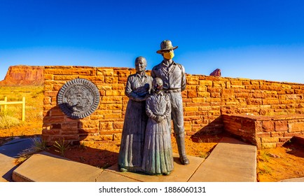 Great Seal of the Navajo Nation and Bronze Navajo Family Statue (with face mask) at the entrance of Monument Valley, which is closed due to COVID-19 pandemic.