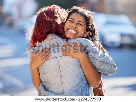 Its so great to see you again. Cropped shot of two attractive young girlfriends hugging while out on the town.