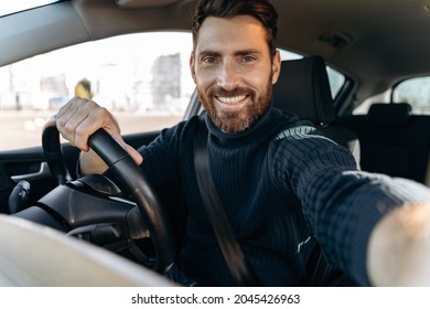 Great Selfie. Handsome Bearded Man Holding Camera And Making Selfie While Sitting In The Car At The Driver Seat And Looking At The Camera With Pleasure Smile