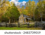 Great Smoky Mountains National Park, Tennessee,  a restored historic log cabin with a split rail fence.