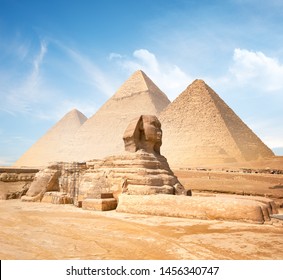 Great sphinx and pyramids under bright sun