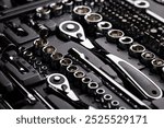 Great studio shot of various tools, socket wrenches arranged in a box.