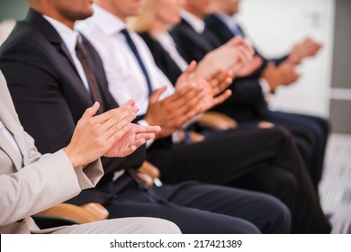 Great Success. Group Of Business People Clapping Hand While Sitting In A Row 