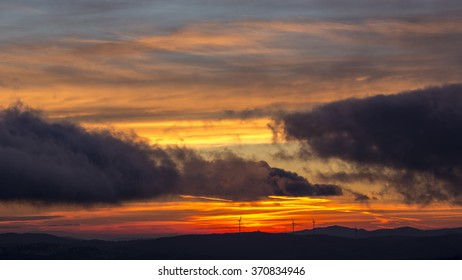 Great Sunrise With Clouds And Red Sky Over Wind Farm