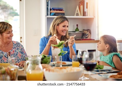 Great Times With Food Before Us And Family Beside Us. Shot Of A Multi Generational Family Enjoying A Meal Together At Home.