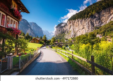 Great view of alpine village glowing by sunlight. Picturesque and gorgeous scene. Popular tourist attraction. Location place Swiss alps, Lauterbrunnen valley, Staubbach waterfall, Europe. Beauty world