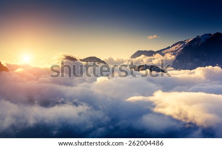 Great view of the foggy Val di Fassa valley with pass Sella. National Park. Dolomites (Dolomiti), South Tyrol. Location Canazei, Campitello, Mazzin. Italy, Europe. Dramatic scene. Beauty world.