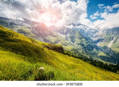 A great view of the green hills glowing by sunlight. Dramatic and picturesque morning scene. Location famous resort Grossglockner High Alpine Road, Austria. Europe. Artistic picture. Beauty world. 