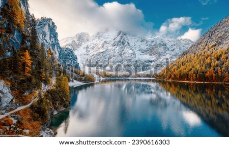 Great view of the mighty rock above peaceful alpine lake Braies (Pragser Wildsee). Location Dolomiti Alps, National park Fanes-Sennes-Braies, Italy, Europe. Photo wallpaper. The beauty of the Earth.