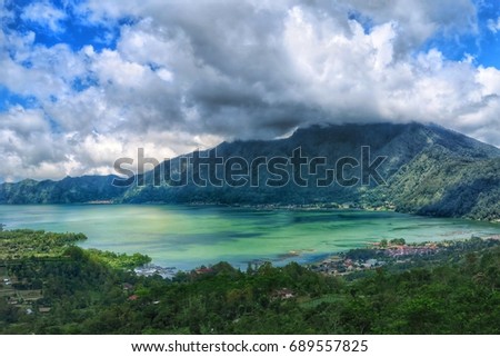 Great view on Kintamani volcano and river in Northern Bali with cloudy sky