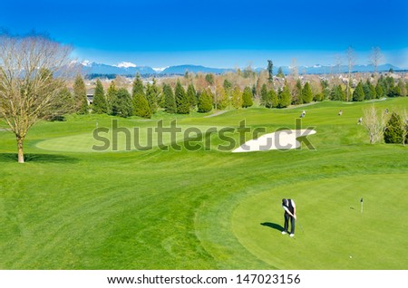 Great view (panorama, outlook ) at the beautiful golf course with the mountains at the back.