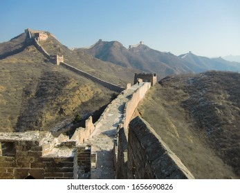 Great Wall Of China - Partly Broken Into Debris Ruin - Reconstruct Repair - Section Between Simatai And Jinshanling With Clear Sky At A Sunny Day - Unlimited Endless Long Way Forward