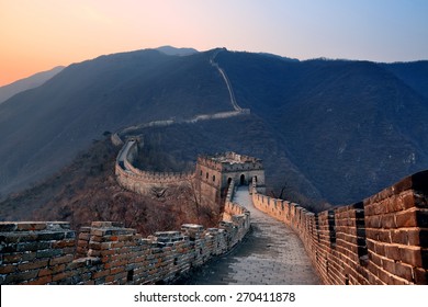 Great Wall sunset over mountains in Beijing, China.
