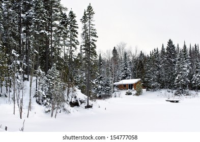 Great Winter Season Landscape With A Wood Cabin And Trees Covered By Snow On A Cold Winter Day, Cottage By A Lake.