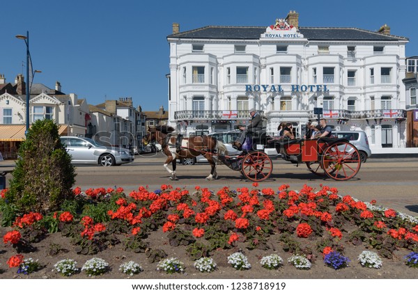 GREAT YARMOUTH, UNITED KINGDOM - JULY 14, 2018 -\
Horse and cart with tourists passing the Royal Hotel on Great\
Yarmouth sea front