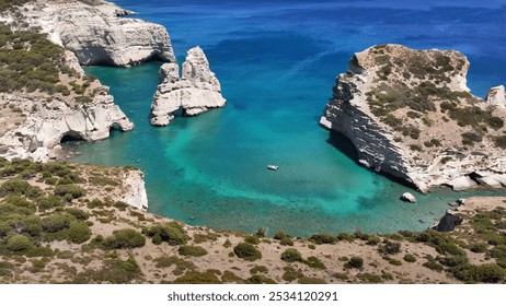 Greece. Aerial view of a serene body of water surrounded by rocks and various plants. It reflects a picturesque outdoor landscape, featuring elements like beaches, cliffs, or islands in the vicinity. - Powered by Shutterstock