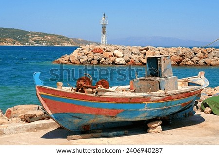 Greece, Chios, an old blue fishingboat on the beach.