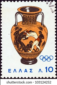 GREECE - CIRCA 1964: A stamp printed in Greece from the "Olympic Games, Tokyo" issue shows Peleus wrestling with Atlanta (amphora) 500 B.C., circa 1964.